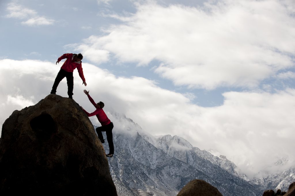 Man helping another man up