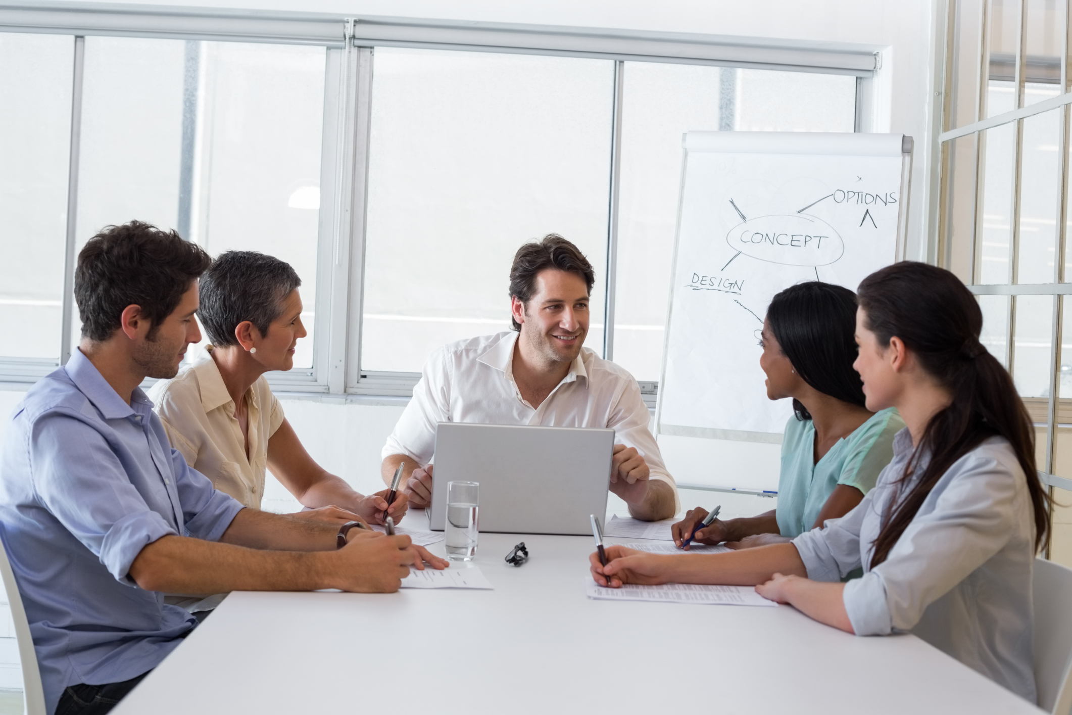 Attractive businessman speaking to coworkers