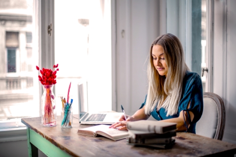 Woman taking notes at a desk